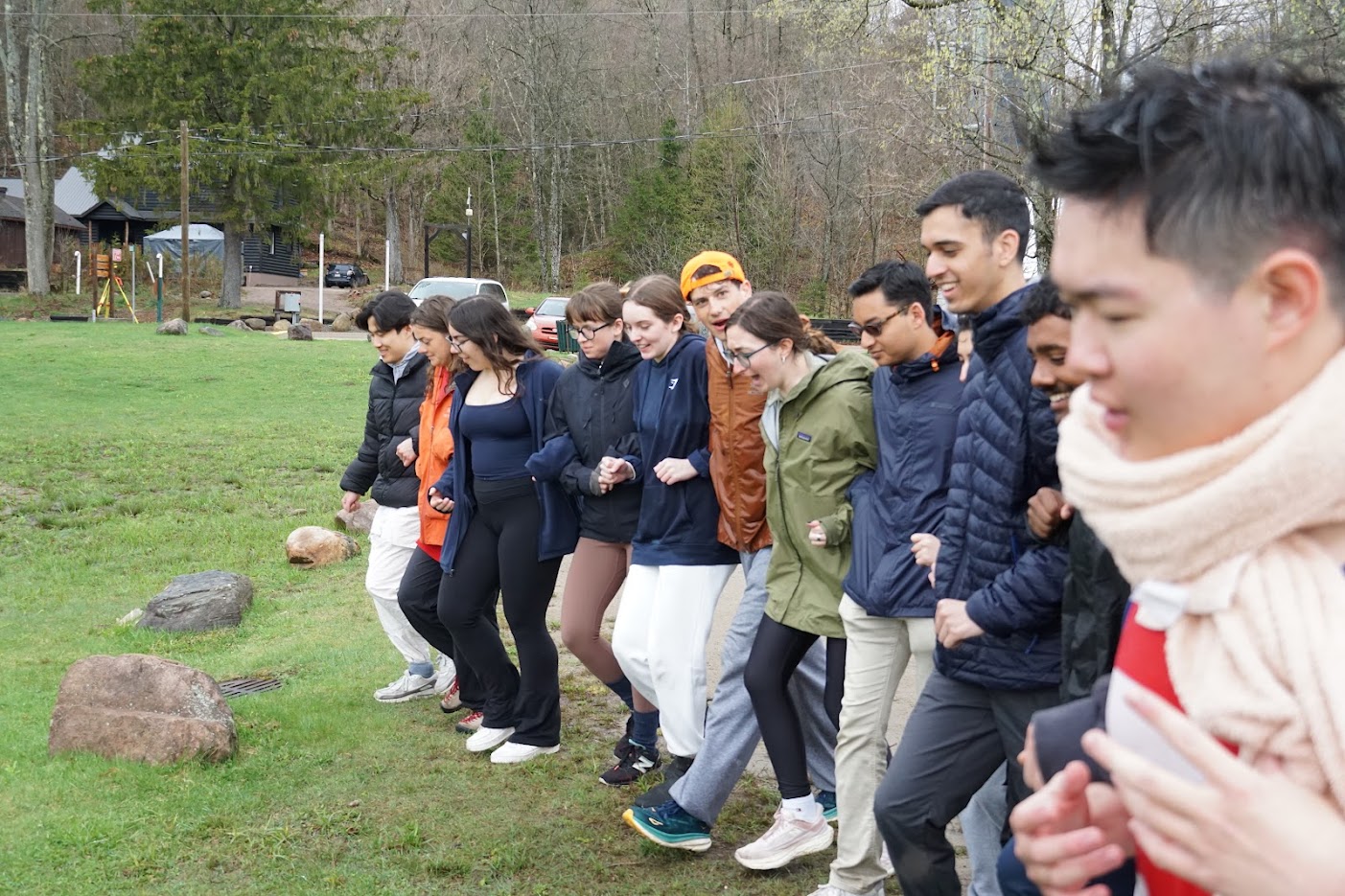 Students walk while interlocking arms with one another